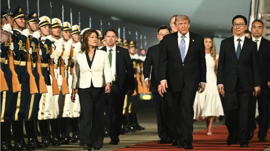 US President Donald Trump (C) is escorted by China's Vice President Han Zheng (R) upon his arrival at Beijing Capital Airport in Beijing on May 13, 2026. (Brendan SMIALOWSKI / AFP via Getty Images)