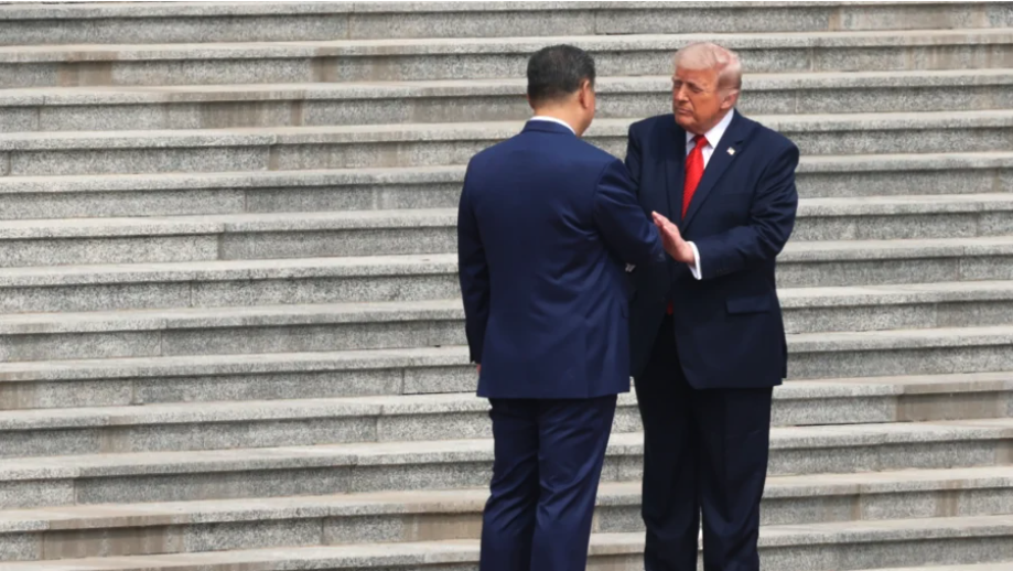 U.S. President Donald Trump (R) is greeted by Chinese leader Xi Jinping during a welcome ceremony in Beijing on May 14, 2026. (Alex Wong/Getty Images)