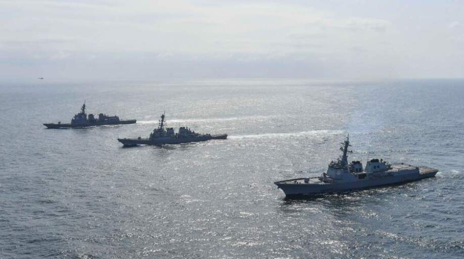 South Korean Navy's destroyer Yulgok Yi I (R), U.S. Navy's USS Benfold (C), and Japan Maritime Self-Defense Force's JS Atago (L) sail in formation during a joint naval exercise in international waters at an undisclosed location on April 17, 2023. (South Korean Defense Ministry via Getty Images)
