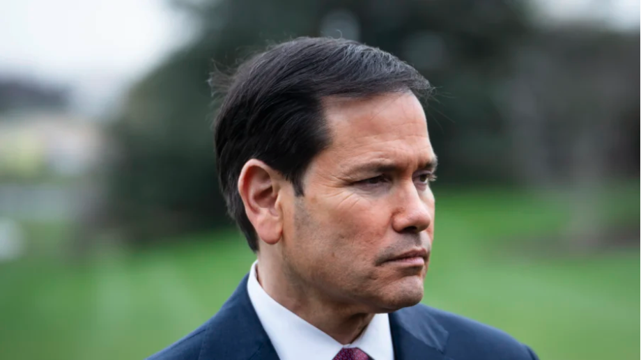 Secretary of State Marco Rubio listens as President Donald Trump speaks to members of the press before departing the White House in Washington on March 20, 2026. (Madalina Kilroy/The Epoch Times)