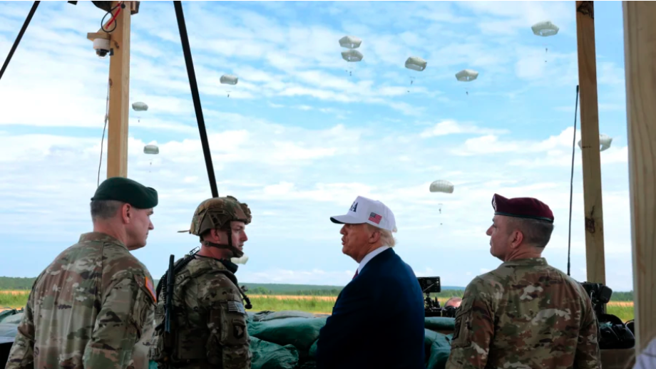 President Donald Trump is joined by 18th Airborne Corps Commander Lt. Gen. Gregory Anderson (R) and other military and civilian leaders as they watch a demonstration by special operations soldiers at the Holland Drop Zone in Fort Bragg, N.C., on June 10, 2025. (Anna Moneymaker/Getty Images)