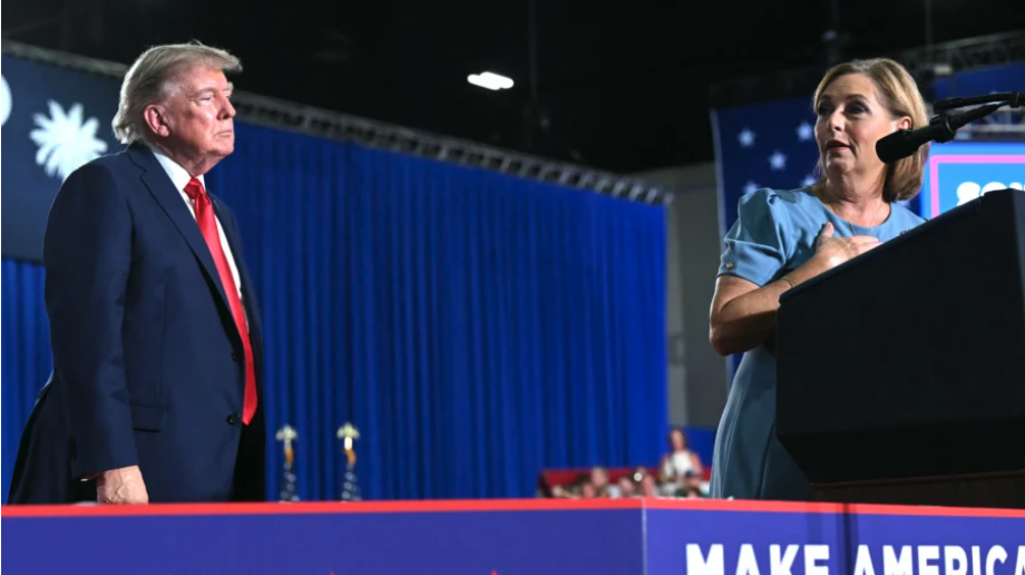 President Donald Trump listens to Sen. Darline Graham (R-S.C.) speak during a campaign rally at Myrtle Beach Convention Center in Myrtle Beach, S.C., on Aug. 21, 2026. (Saul Loeb/AFP via Getty Images)